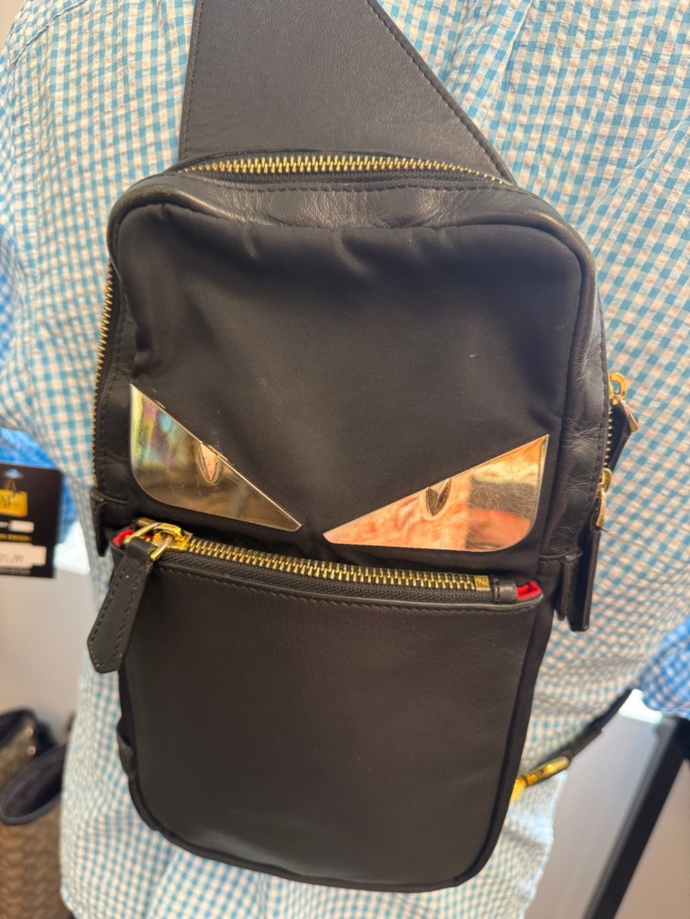 Fendi Black women Sling Bag pack with Gold Eye Accents
